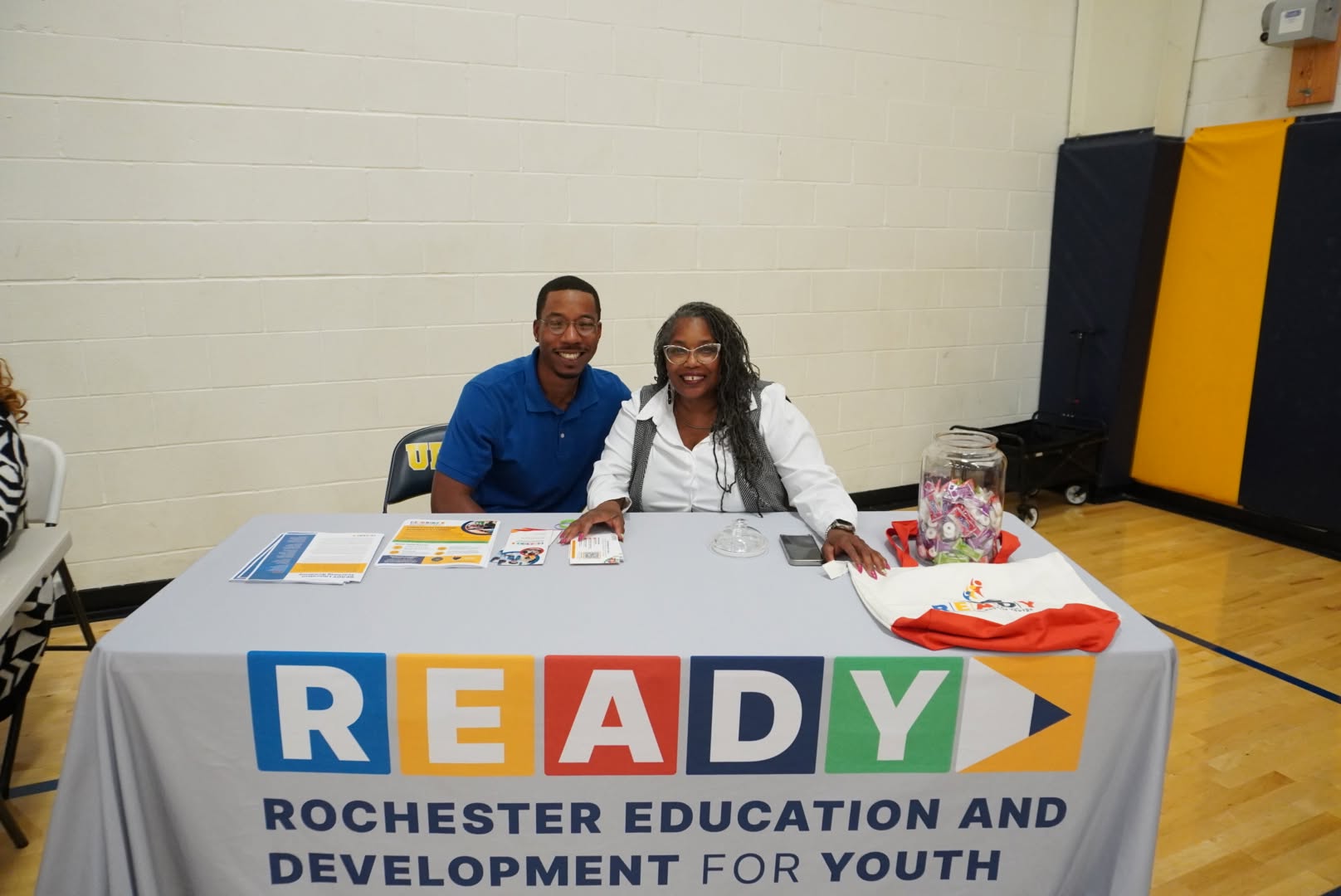 Two UPrep partners staffing a READY resource table at a community event