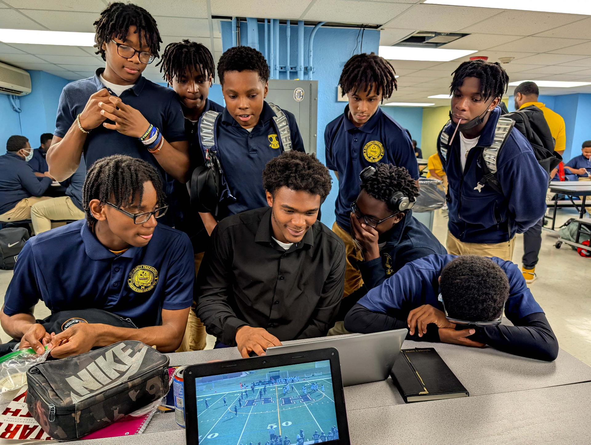 UPrep students gathered around a laptop watching game film during lunch