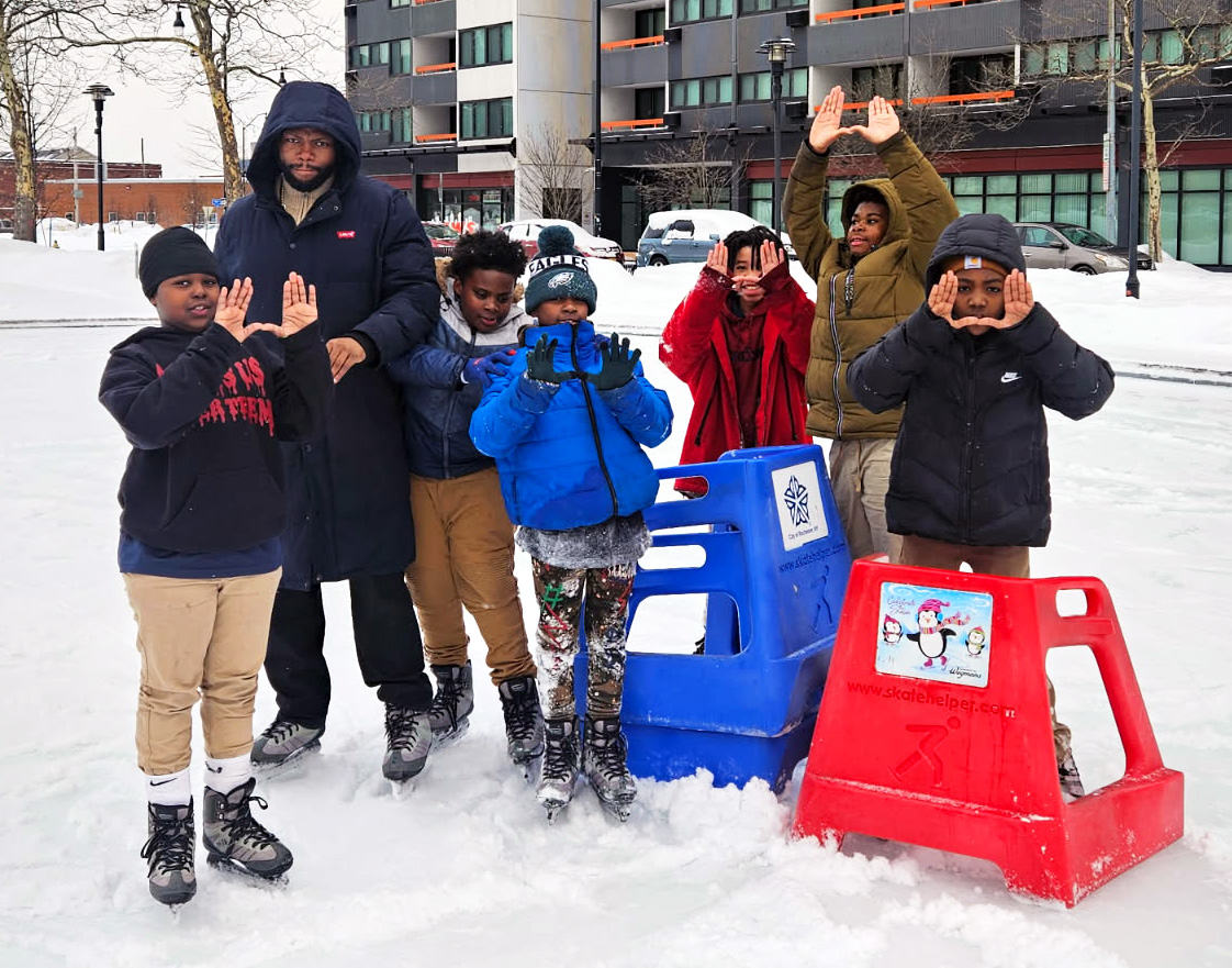 Sixth grade UPrep students and a staff member ice skating downtown in winter