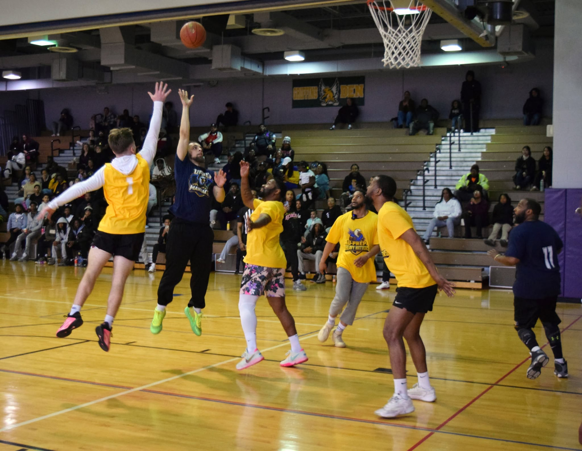 A UPrep player rising for a jump shot in a packed gym