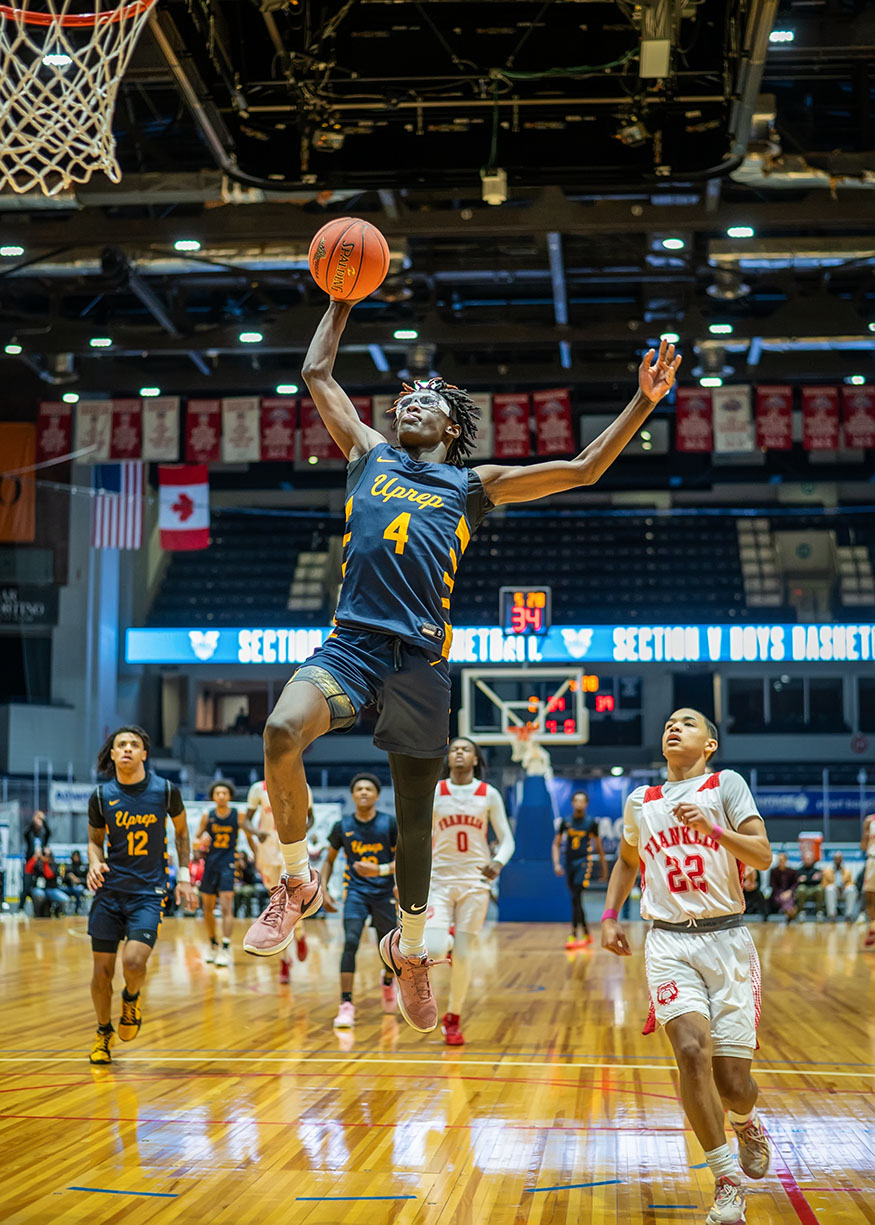 A UPrep basketball player finishing a dunk during the Section V finals